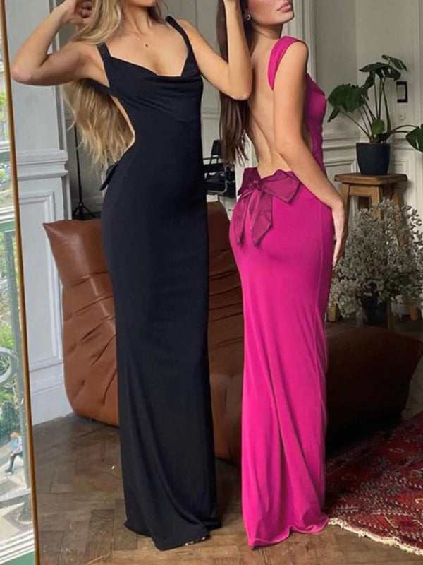 Two women wearing black and pink evening gowns in a room with decor elements.