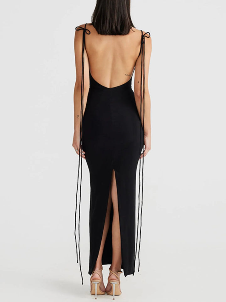 Black maxi dress with open back and side slits on a white background