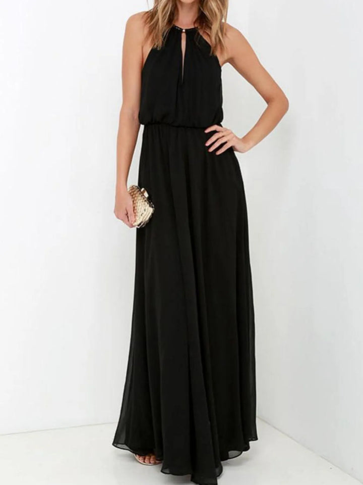 Woman wearing a black halter neck dress on a white background