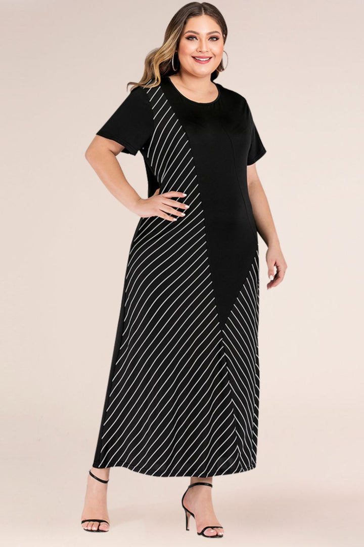 Woman wearing a black maxi dress with white stripes on a beige background