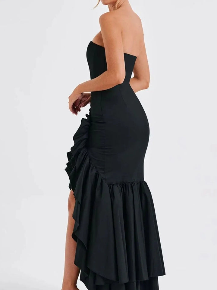 Black strapless dress with ruffled skirt on a white background