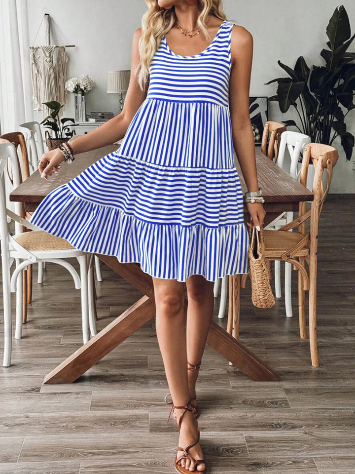 Woman wearing a blue and white casual striped dress in a dining room.