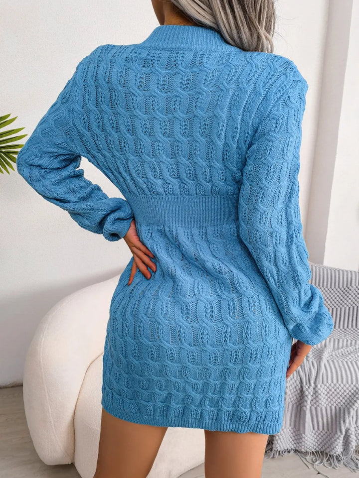 Blue knitted dress worn by a person, with a neutral background