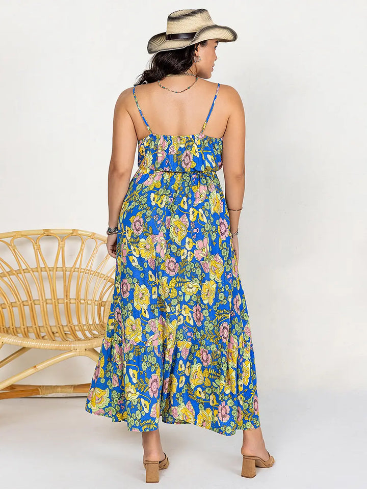 Woman wearing a dusty blue floral dress with a white background