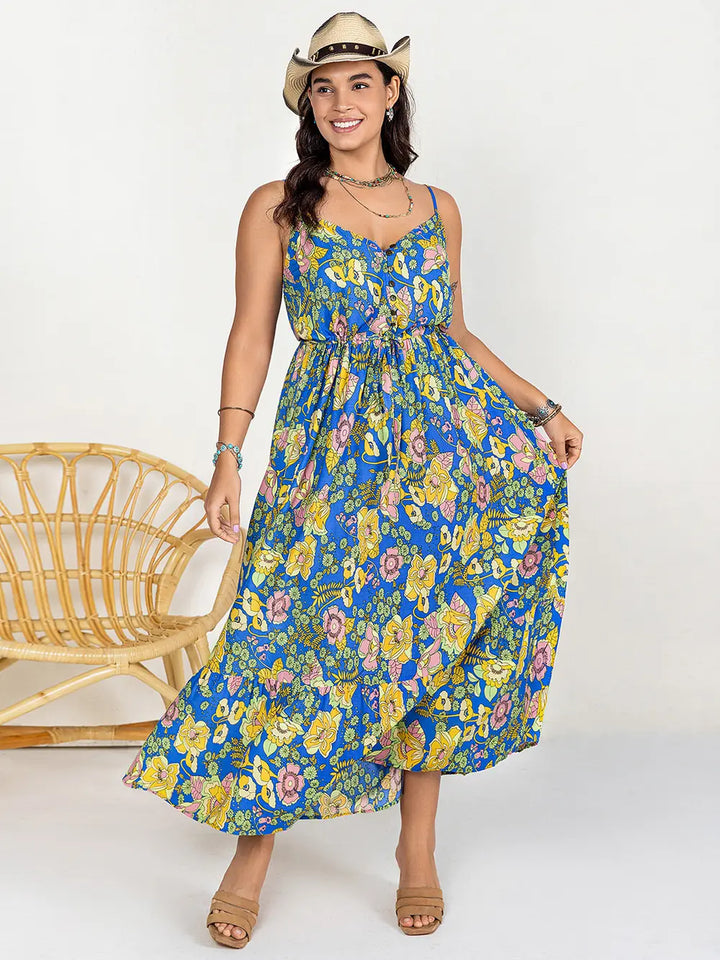 Woman wearing a dusty blue floral dress with a white background