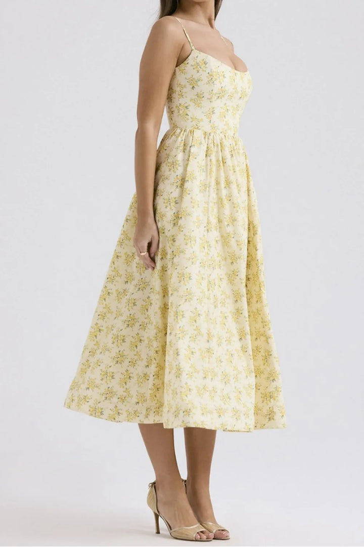 Woman wearing a yellow floral dress on a white background