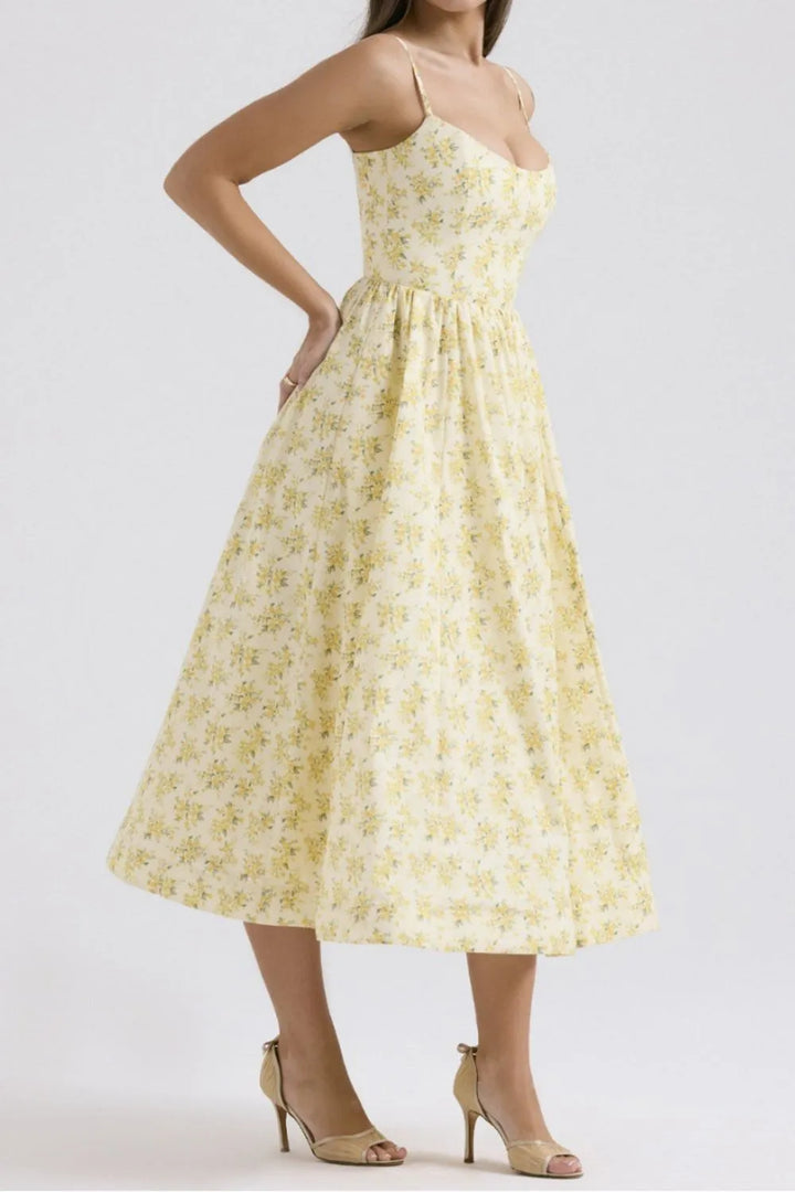 Woman wearing a yellow floral dress on a white background
