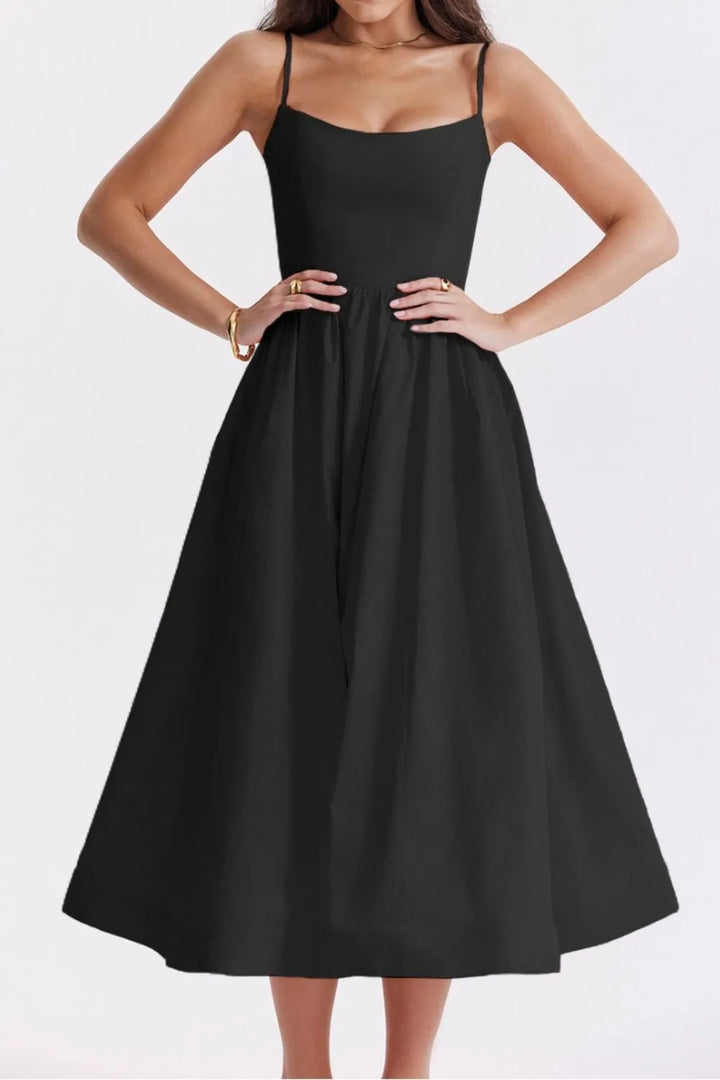Black dress worn by a model on a white background