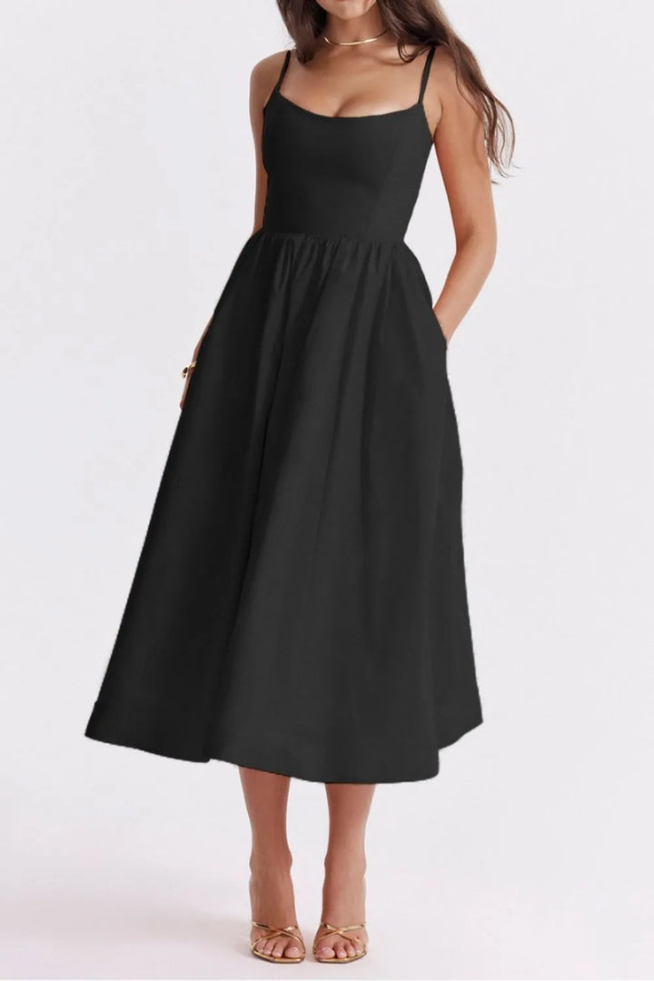 Black dress worn by a model on a white background