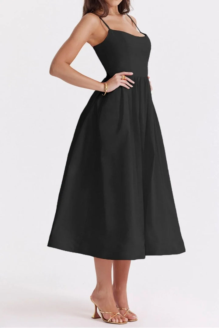 Black dress worn by a model on a white background