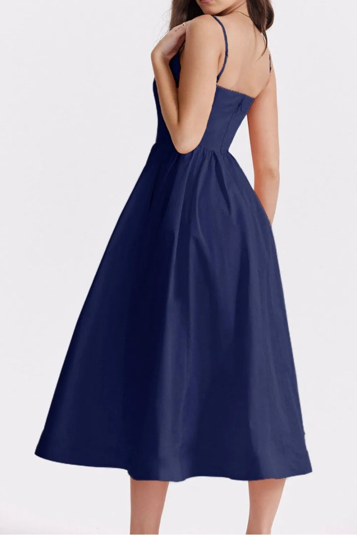 Navy blue dress with thin straps on a white background
