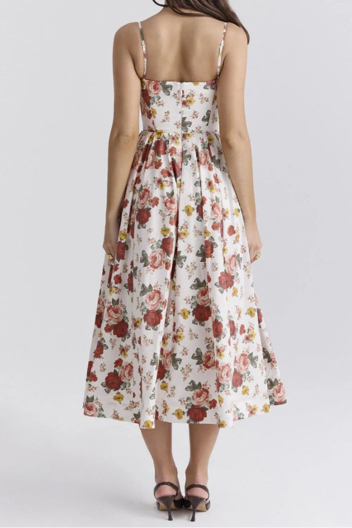 Woman wearing a floral dress on a white background, back angle