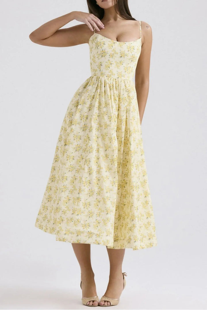 Woman wearing a yellow floral dress on a white background