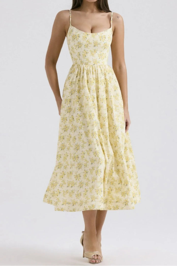 Yellow floral dress worn by a model on a white background