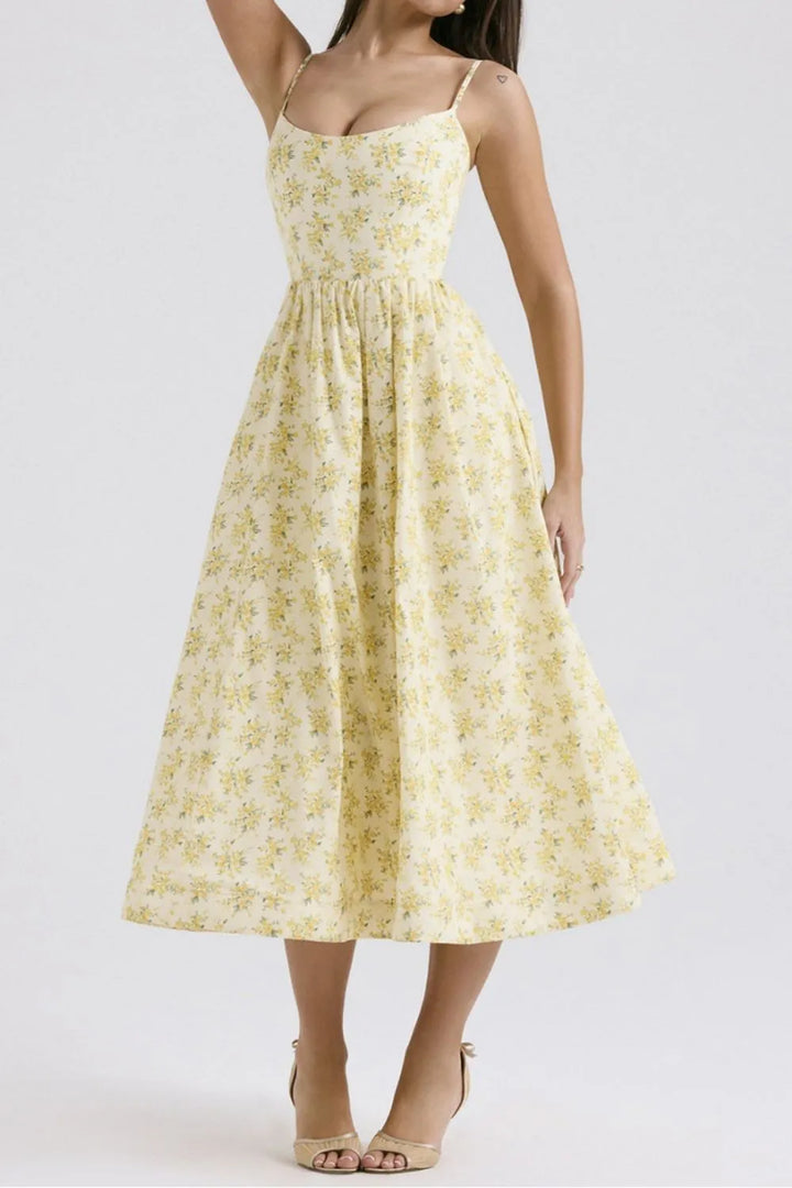 Woman wearing a yellow floral dress on a white background