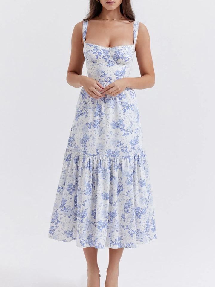 Woman wearing a white dress with blue floral pattern on a white background