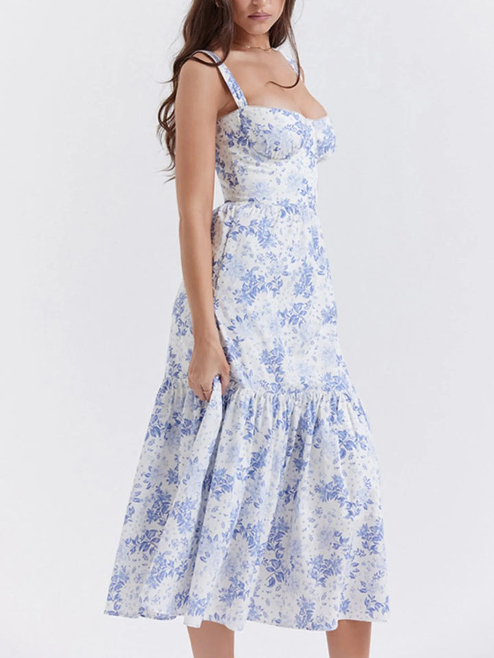 Woman wearing a blue floral dress on a white background
