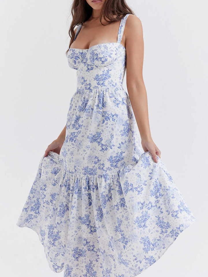 Woman wearing a white floral dress with blue flowers on a white background