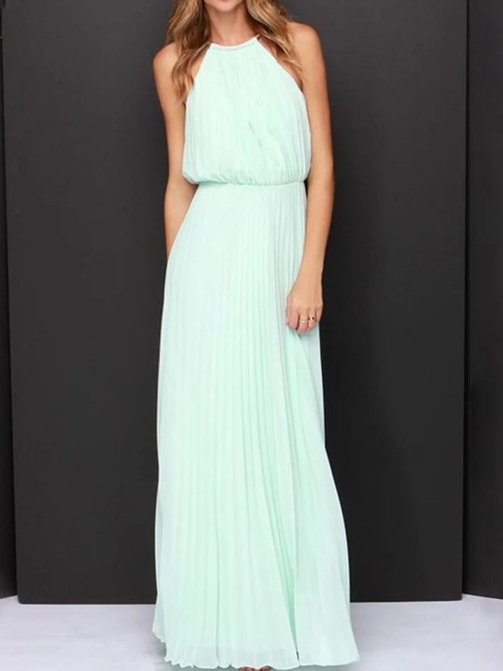 Mint green halter neck gown on a plain background