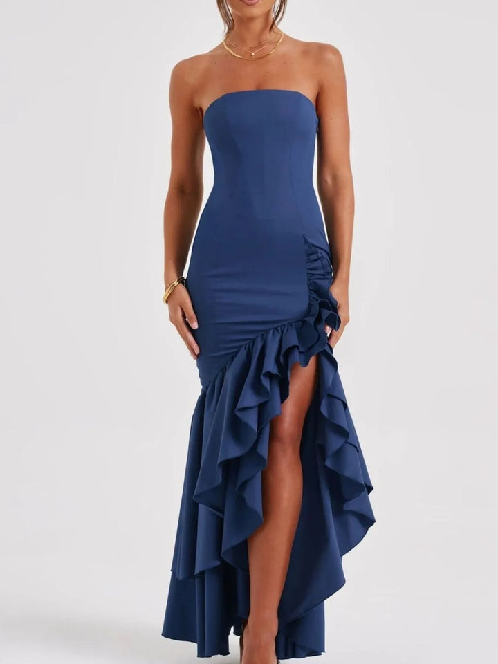 Navy strapless dress with ruffled skirt on a white background