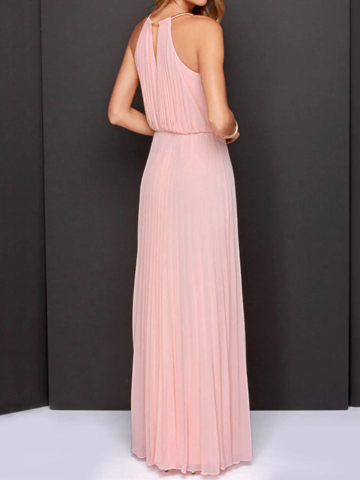 Pink evening gown on a model against a dark background