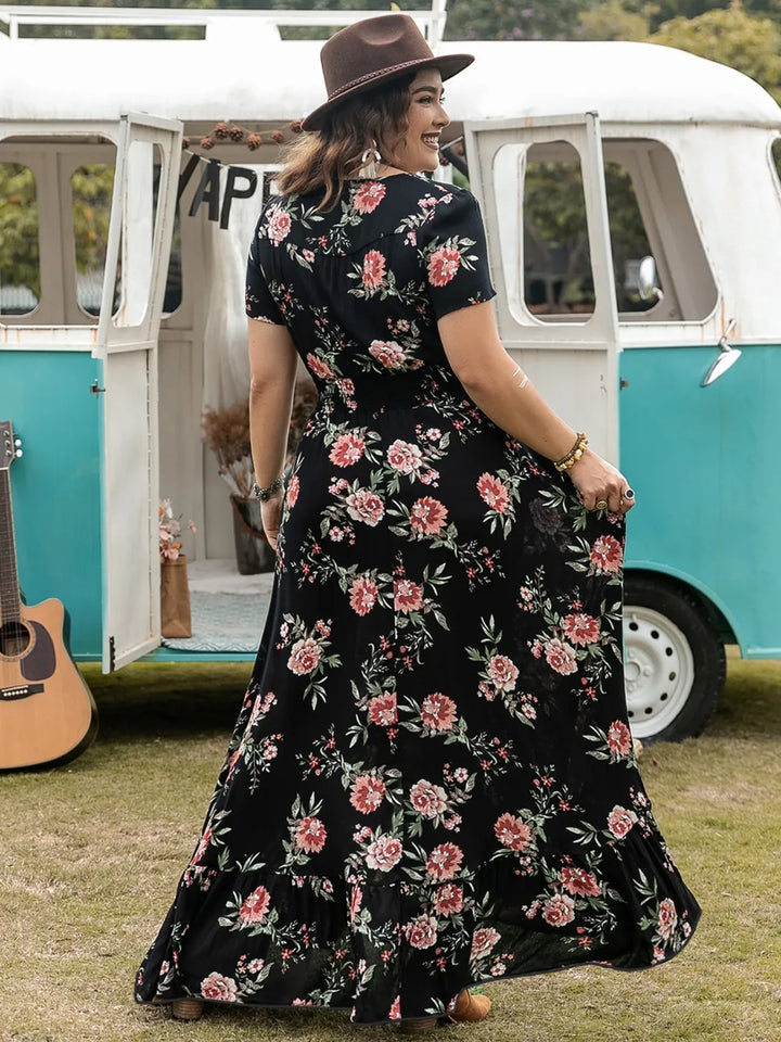 Woman in a floral maxi dress standing in front of a vintage van with a guitar.