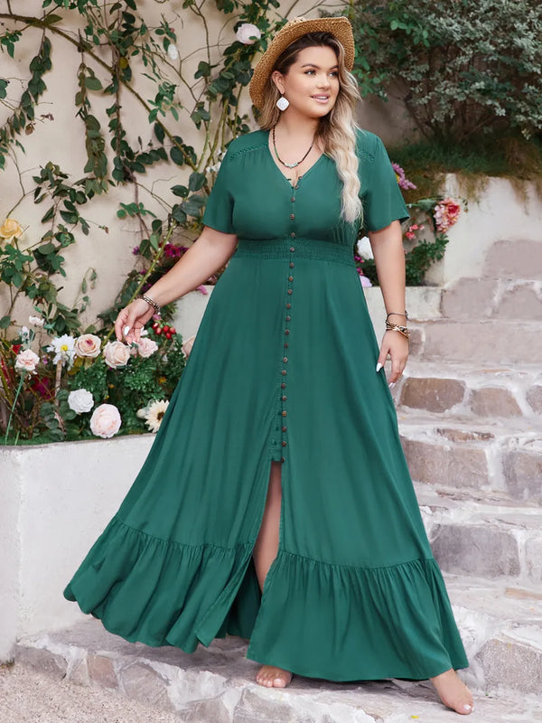 Woman wearing a teal maxi dress with a floral background