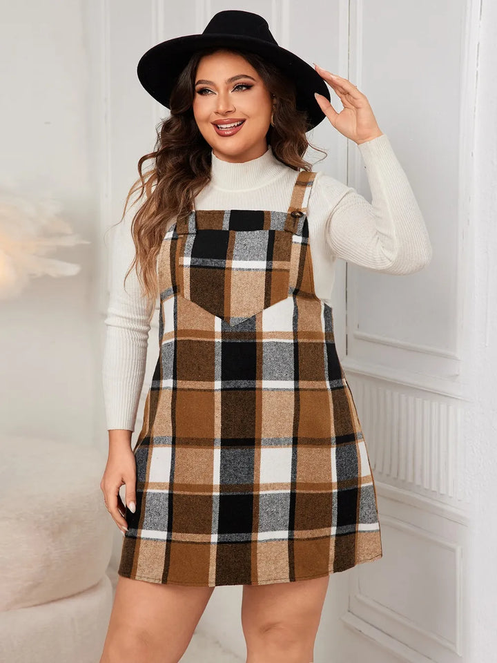Woman wearing a plaid casual dress and black hat indoors