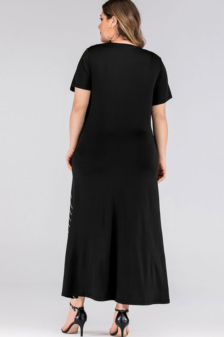 Woman wearing a black maxi dress with a plain background