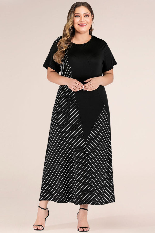 Woman wearing a black maxi dress with white striped pattern on a beige background