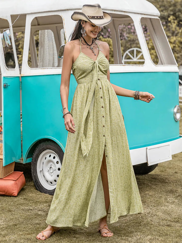 Woman in a green maxi dress standing in front of a vintage turquoise and white van.