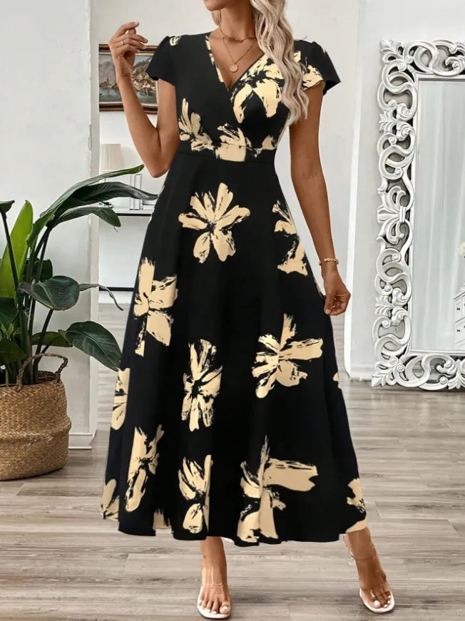 Woman wearing a black dress with gold floral patterns in a home setting.
