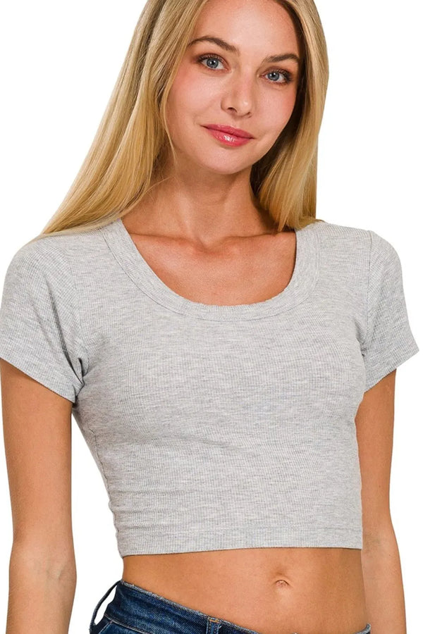 Woman wearing a gray crop top on a white background
