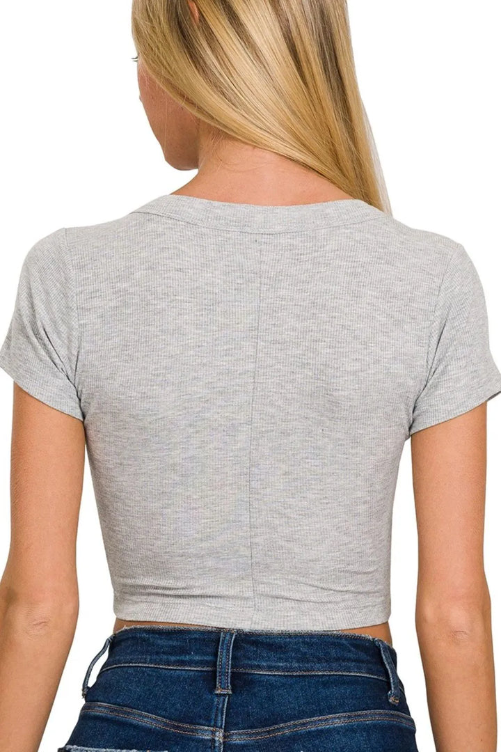 Gray crop top worn by a person on a white background
