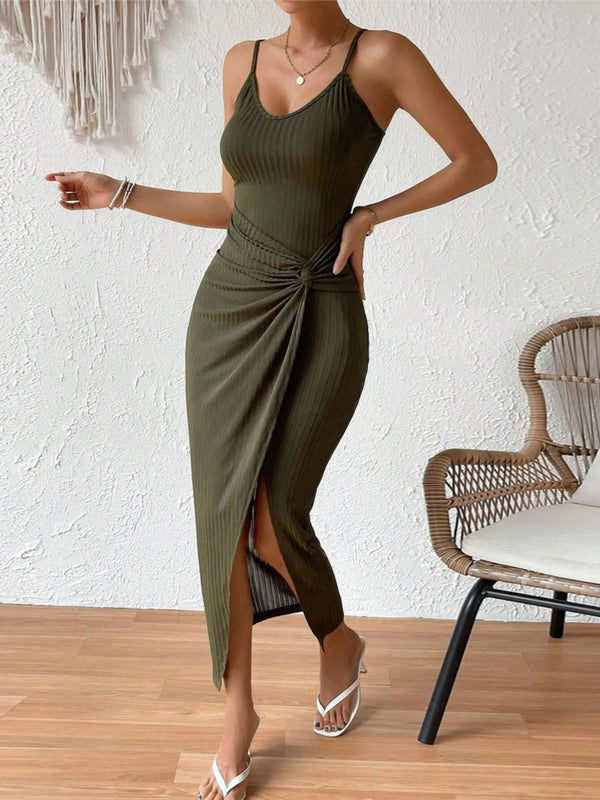 Woman wearing a green slit dress with a white background
