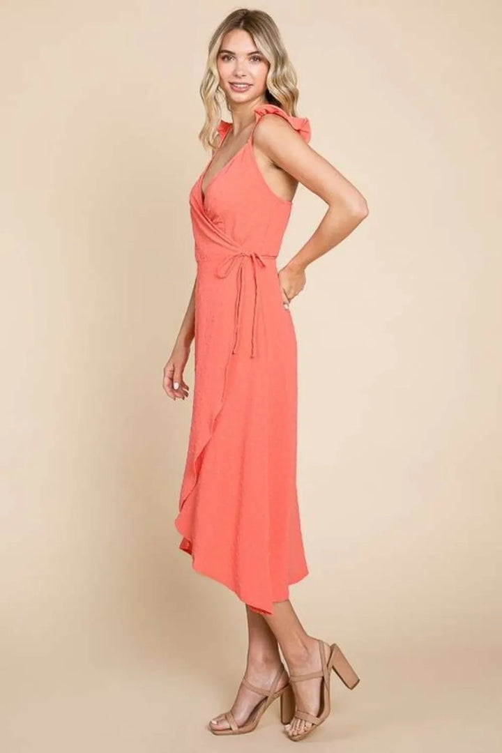 Woman wearing a coral dress against a beige background