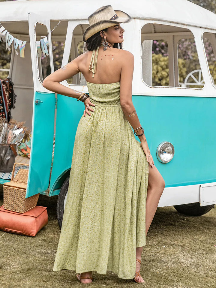 Woman in a sage maxi dress and cowboy hat standing in front of a vintage turquoise and white van.