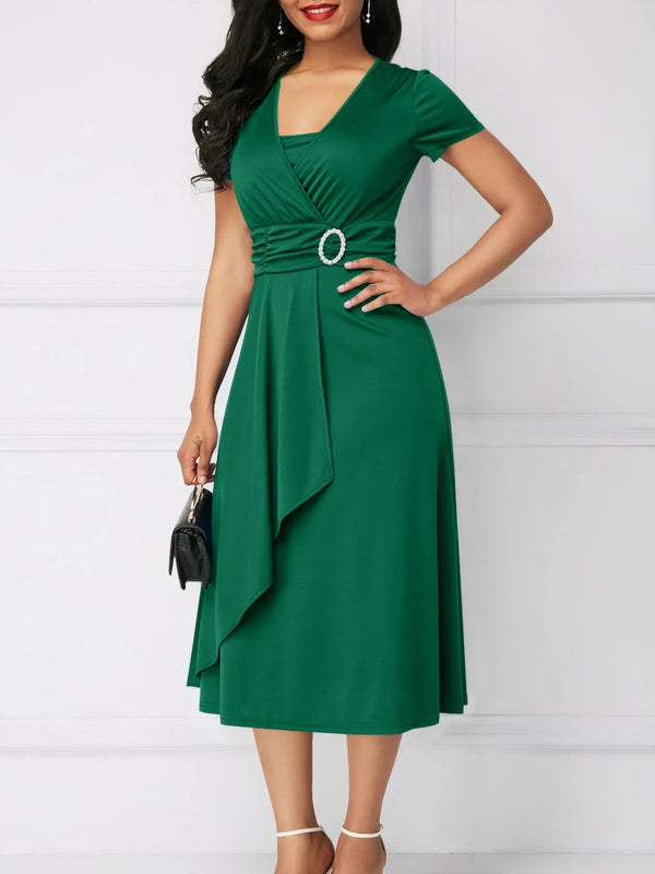 Green dress with a belt worn by a model against a white background