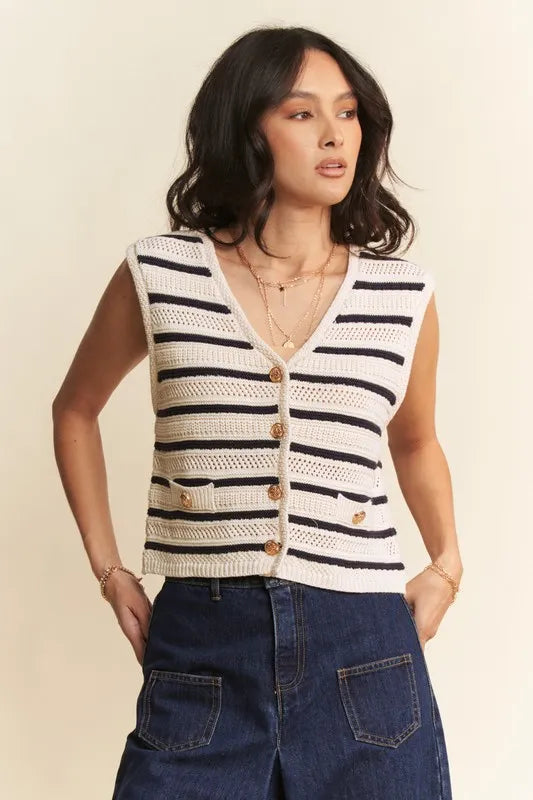 Woman wearing a striped sleeveless crochet top with buttons on a beige background