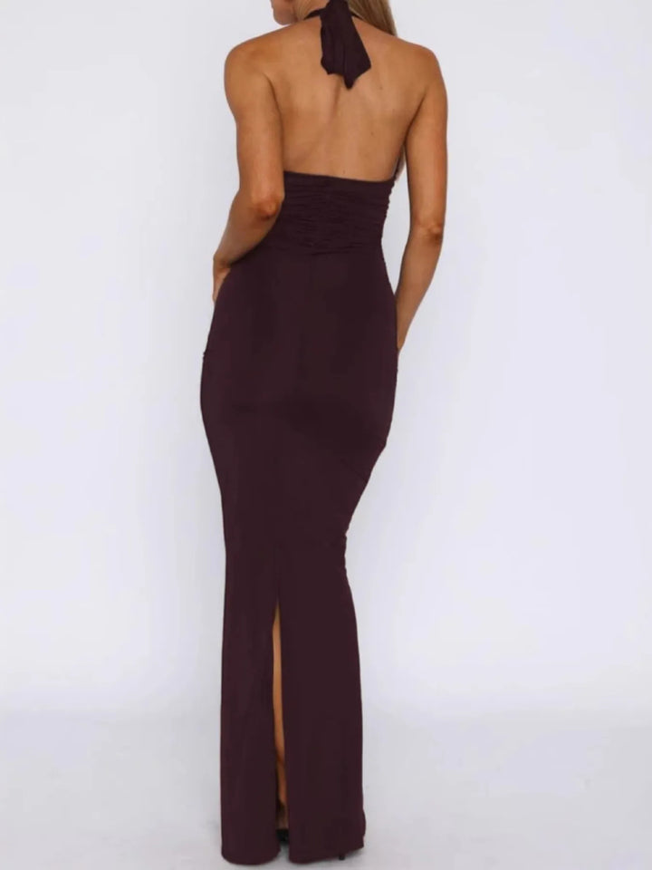 wine red halter neck gown with a slit on a white background