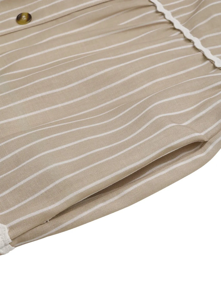 Close-up of tan fabric with white stripes and a button on a white background