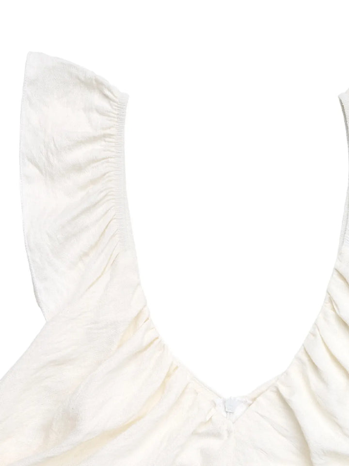 Close-up of a white swimsuit with thin straps on a white background